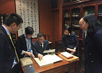 Mr. Li Xiaohong, Vice-chairman of the International Finance Forum appreciates the beauty of the Chinese Rare Book Collection, together with CUHK members